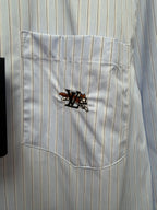 Light blue pinstripe chest pocket with embroidered crest emblem