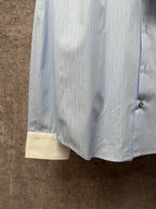 Light blue pinstripe shirt hem with cream cuff panels and side button