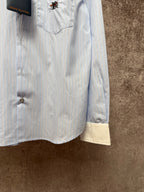 Light blue pinstripe button-up shirt with cream hem facing and front buttons