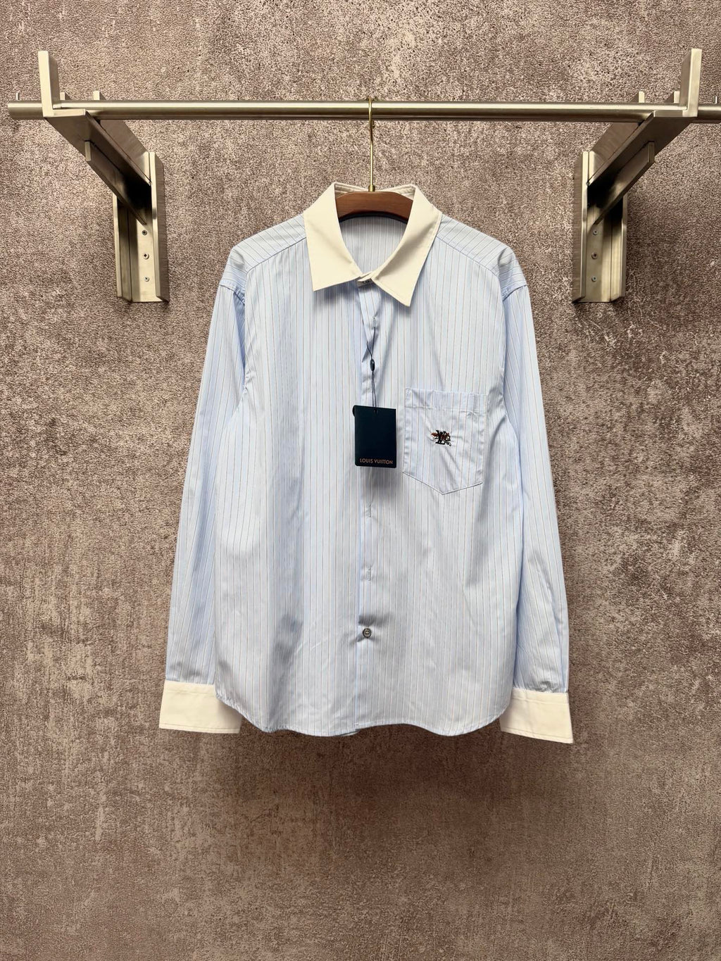 Light blue pinstripe button-up shirt with cream collar and chest pocket