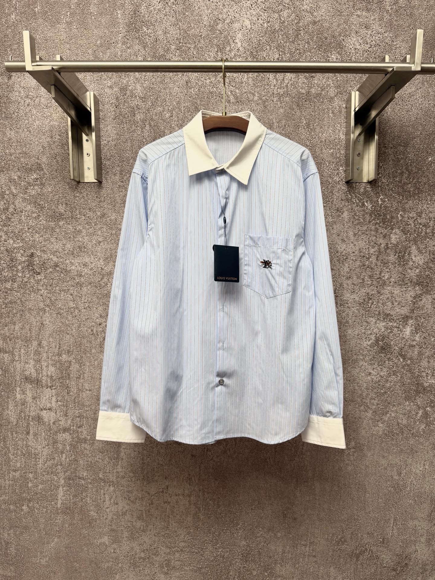 Light blue pinstripe button-up shirt with cream collar and chest pocket
