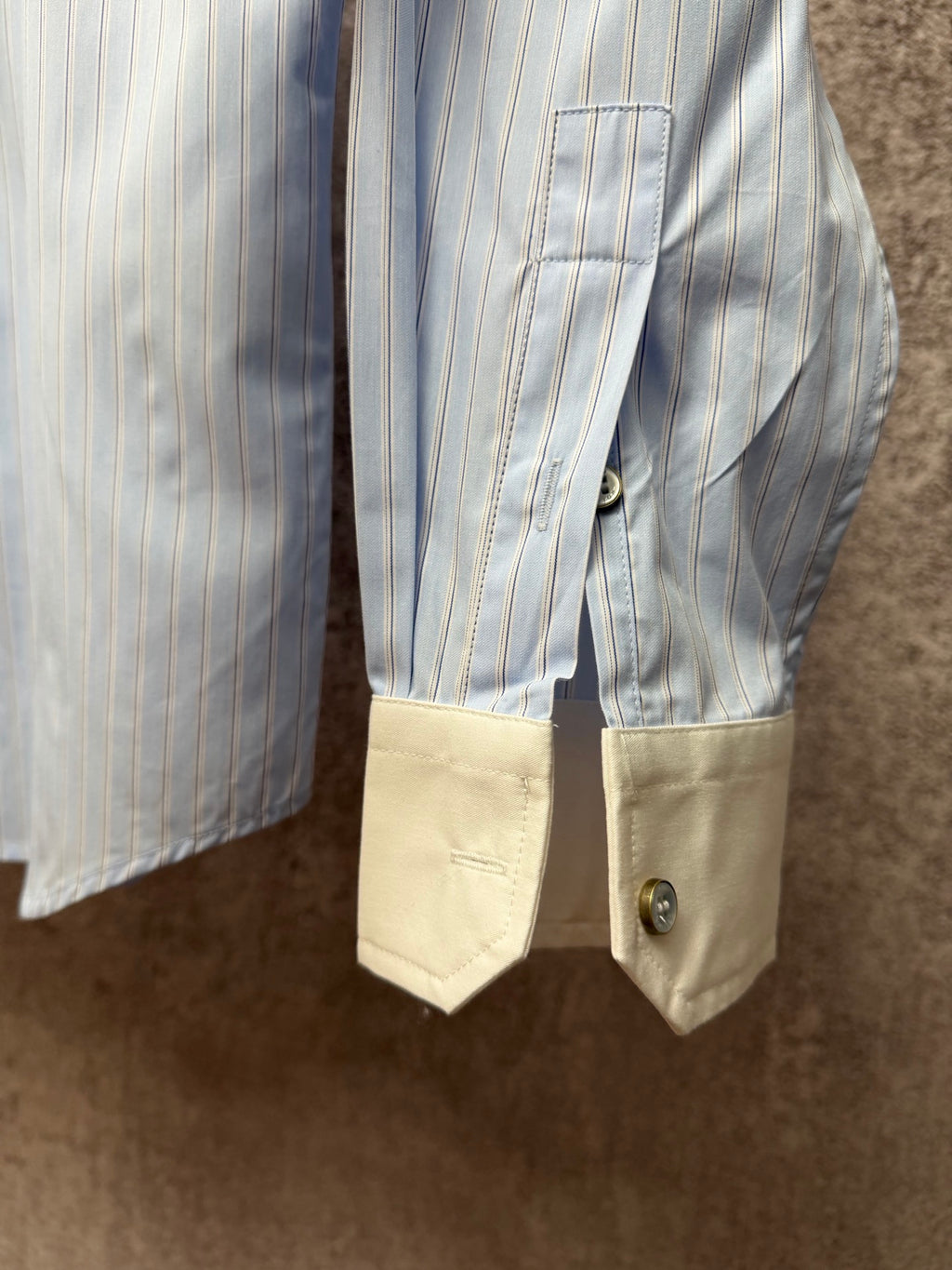 Light blue pinstripe shirt with cream cuff panels and buttoned pocket flap