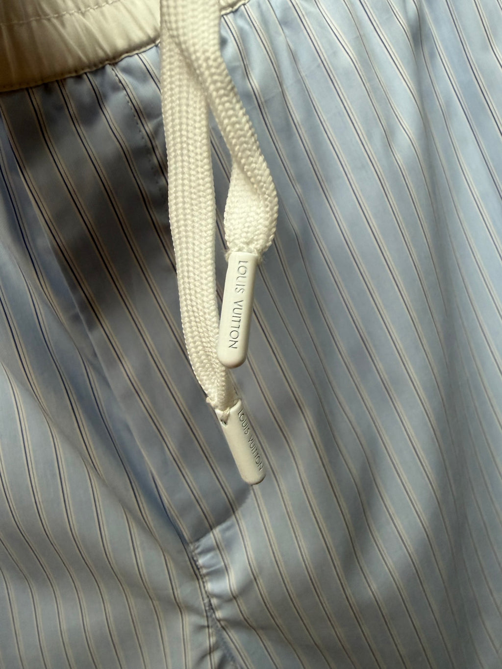 White drawstring with logo tag on light blue pinstripe shorts, Louis Vuitton