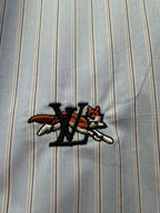 Embroidered logo on light blue striped fabric with black and red accents