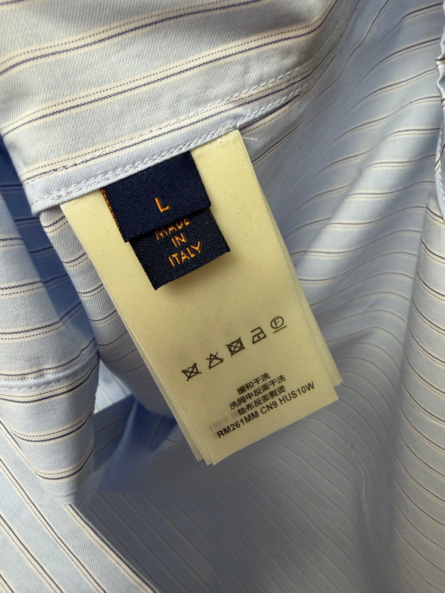 Light blue striped shirt care label and size tag inside