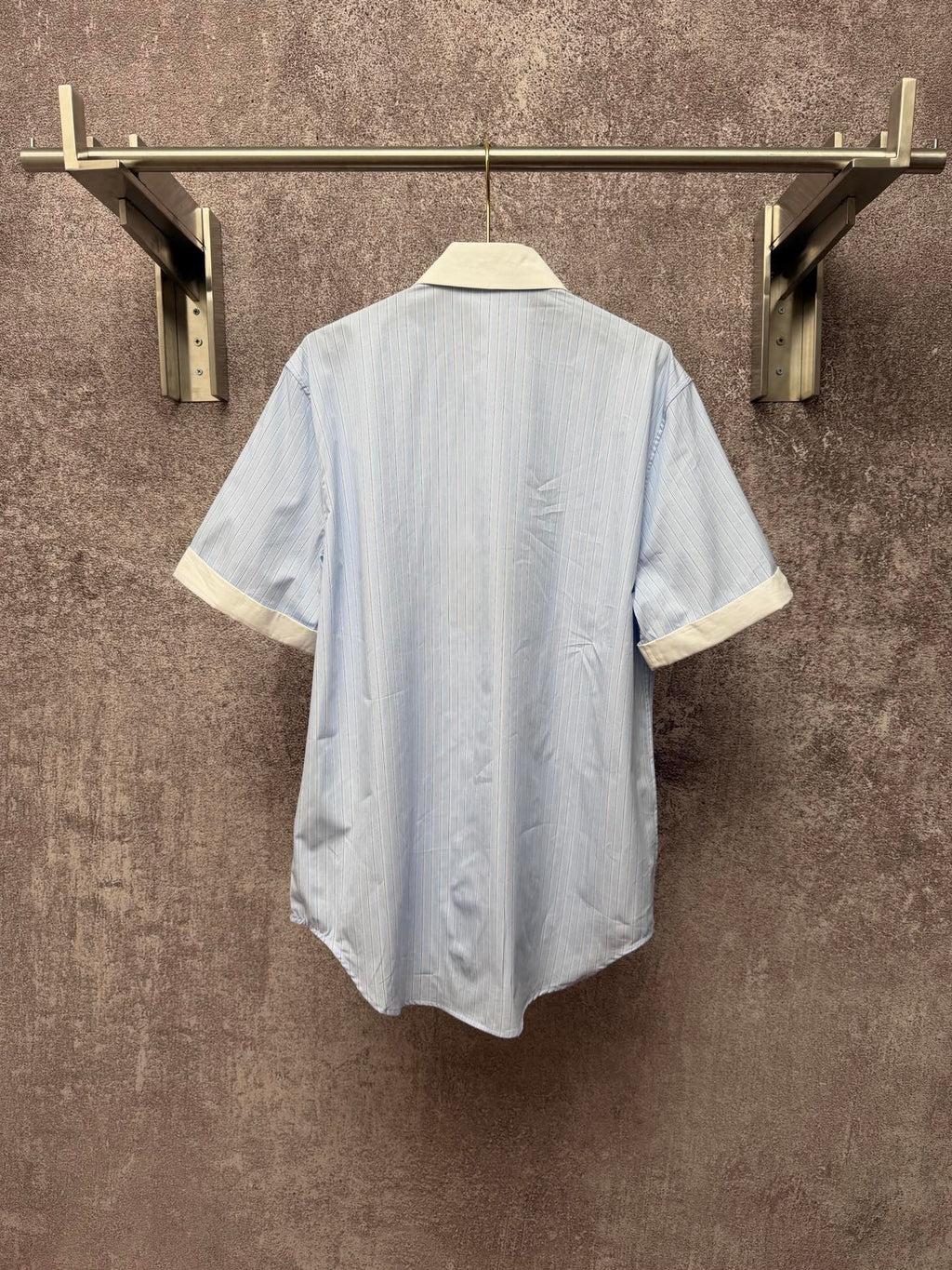 Light blue striped short-sleeve shirt with cream collar trim, back view