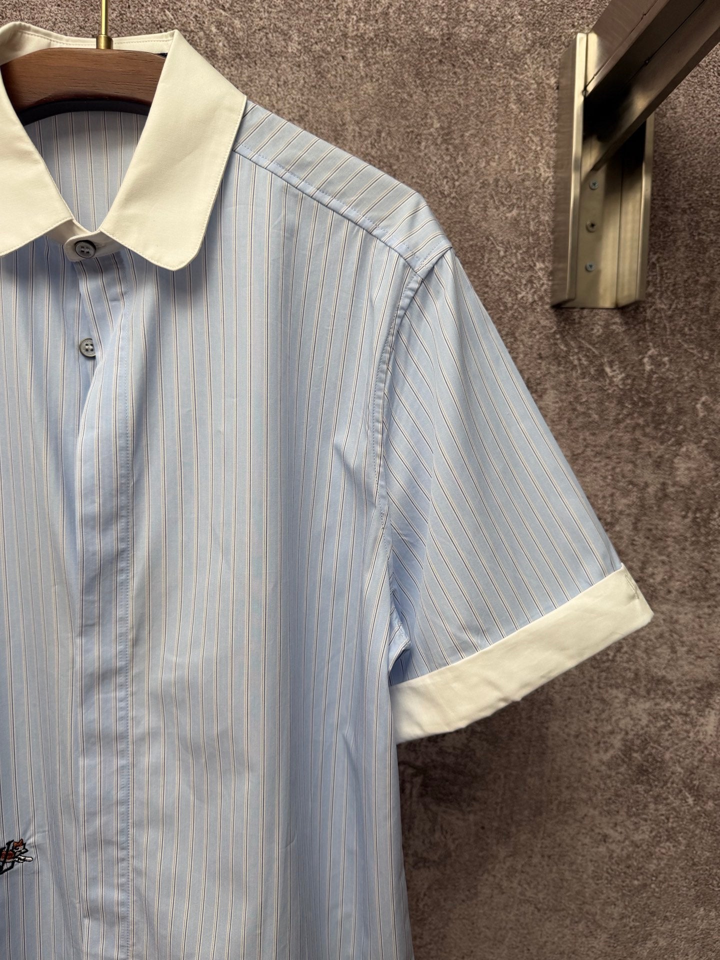 Light blue striped short-sleeve shirt with cream collar and sleeve cuff detail