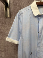 Light blue striped short-sleeve shirt with cream collar and front button placket