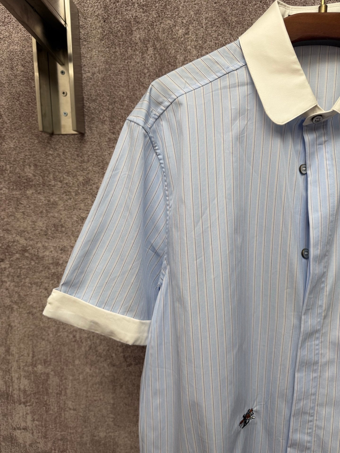 Light blue striped short-sleeve shirt with cream collar and front button placket