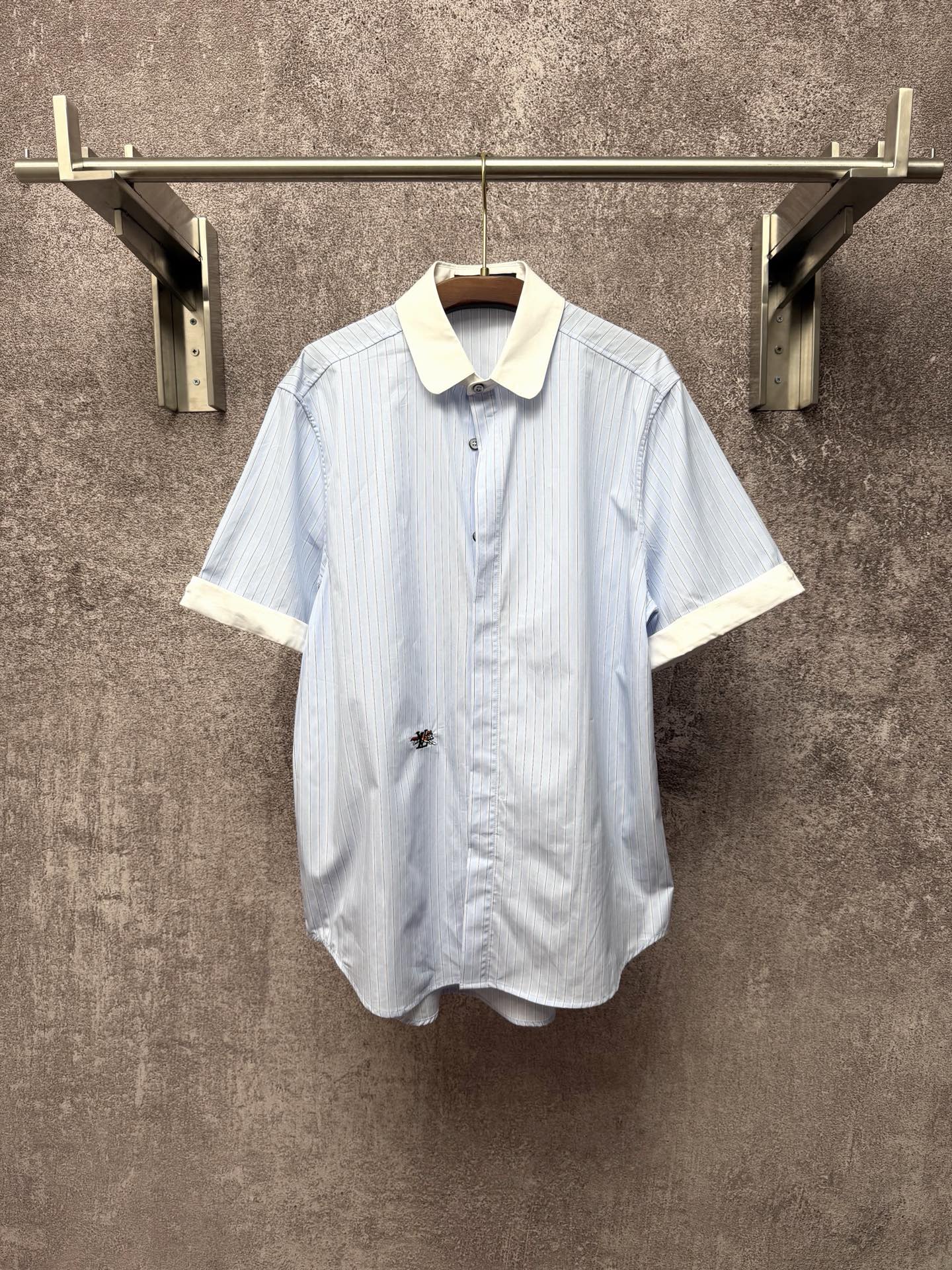 Light blue striped short-sleeve button shirt with cream pointed collar and cuffs