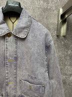 Light blue denim jacket with spread collar, button placket, and two chest flap pockets