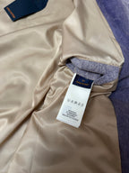 Beige long-sleeve outerwear with denim cuff and hanging size label