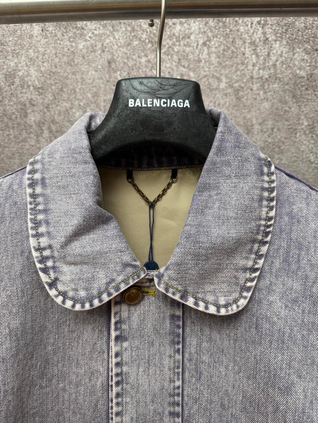 Light blue denim jacket collar and front placket with two-button closure