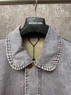 Light blue denim jacket collar and front placket with two-button closure