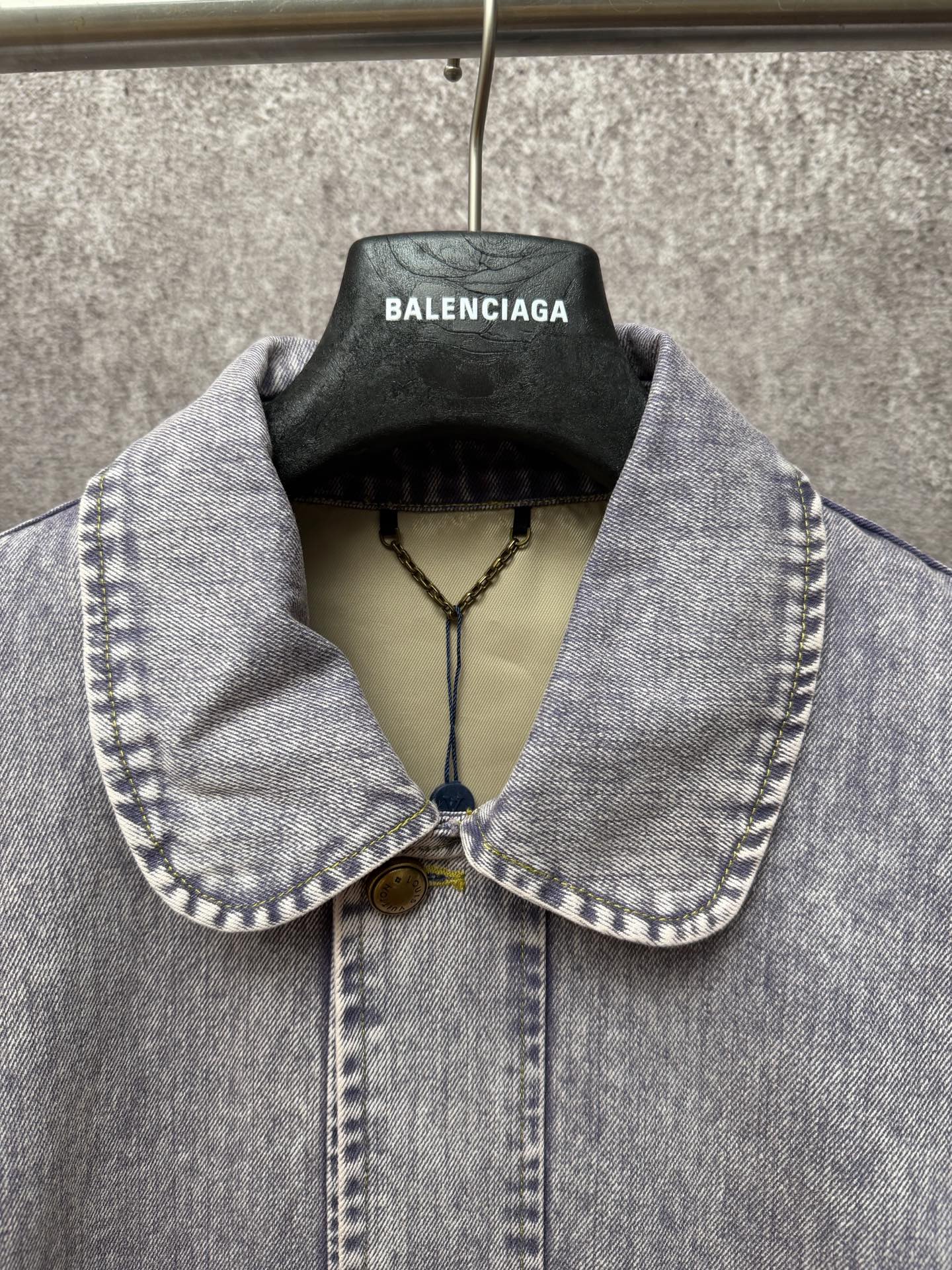 Light blue denim jacket collar and front placket with two-button closure