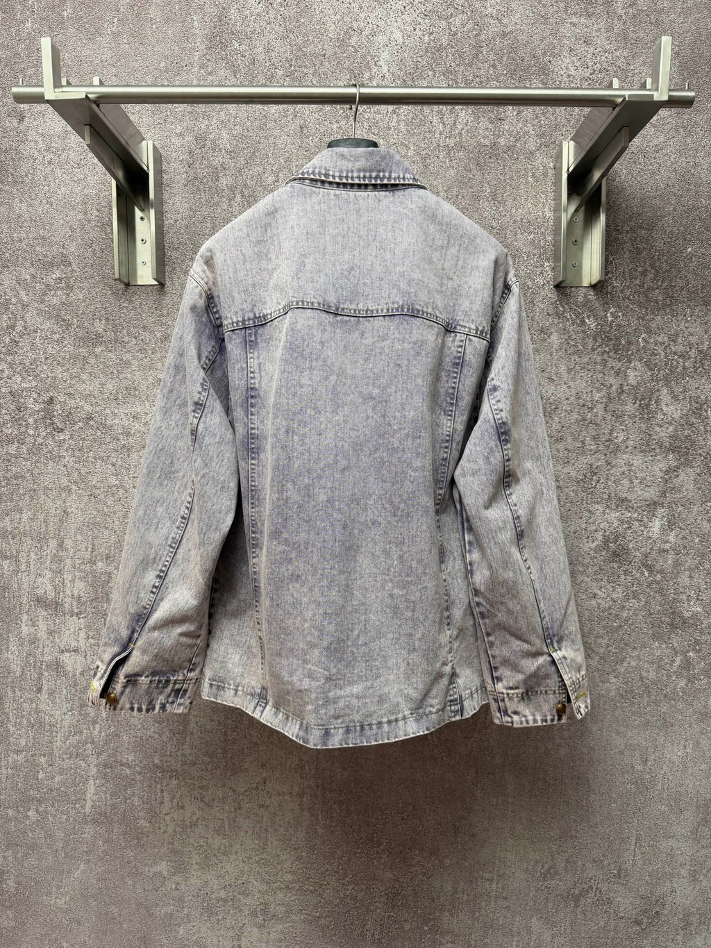 Light blue denim jacket back view with yoke seam and stitched collar