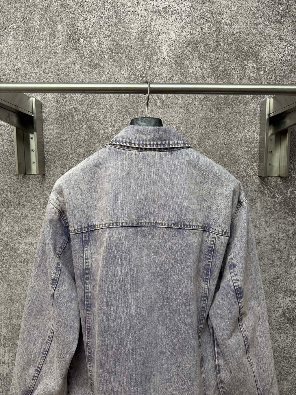 Light blue denim jacket back view with yoke seam and stitched collar