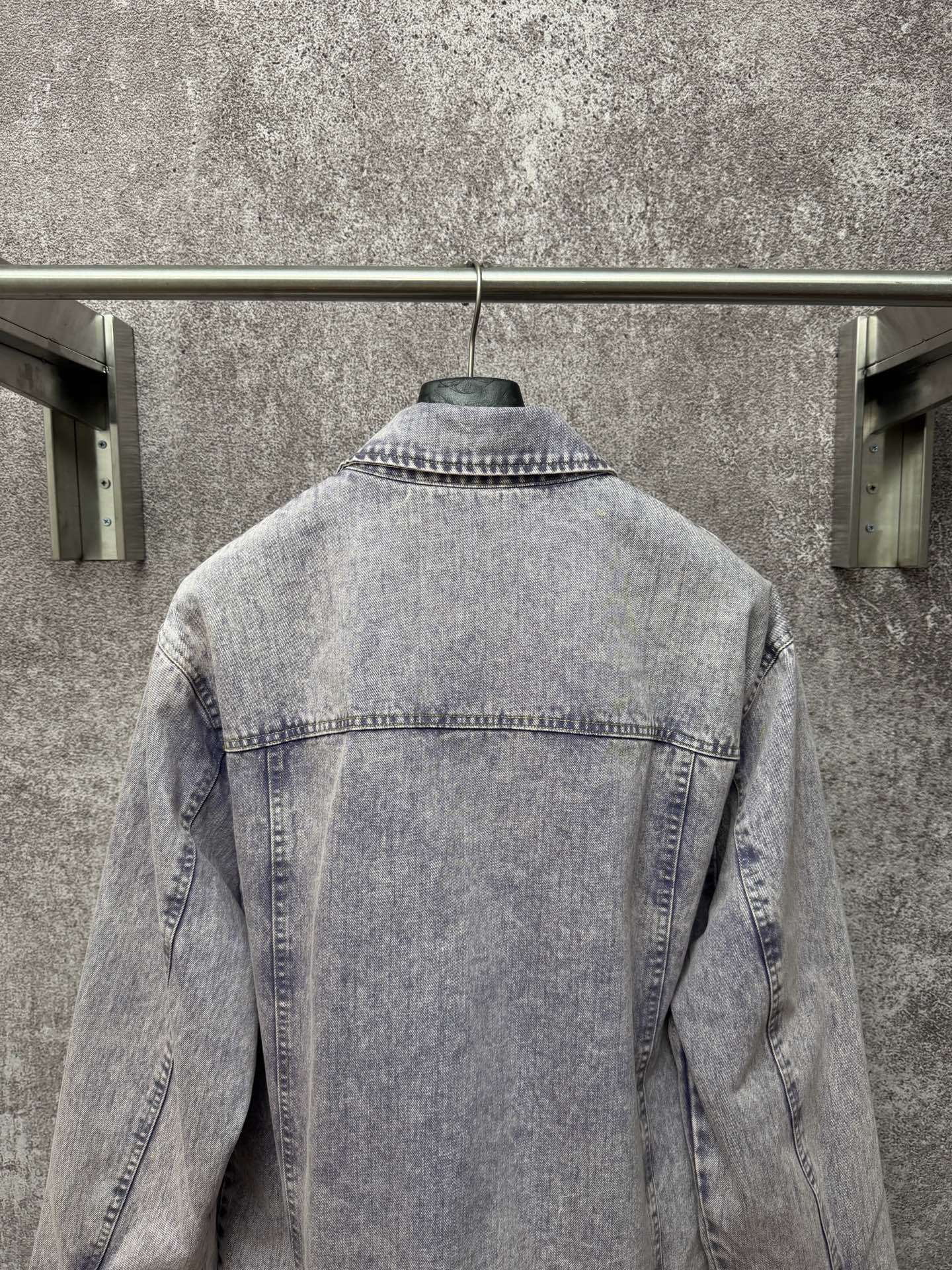 Light blue denim jacket back view with yoke seam and stitched collar