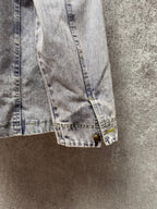 Light blue denim jacket cuff with button and stitched hem