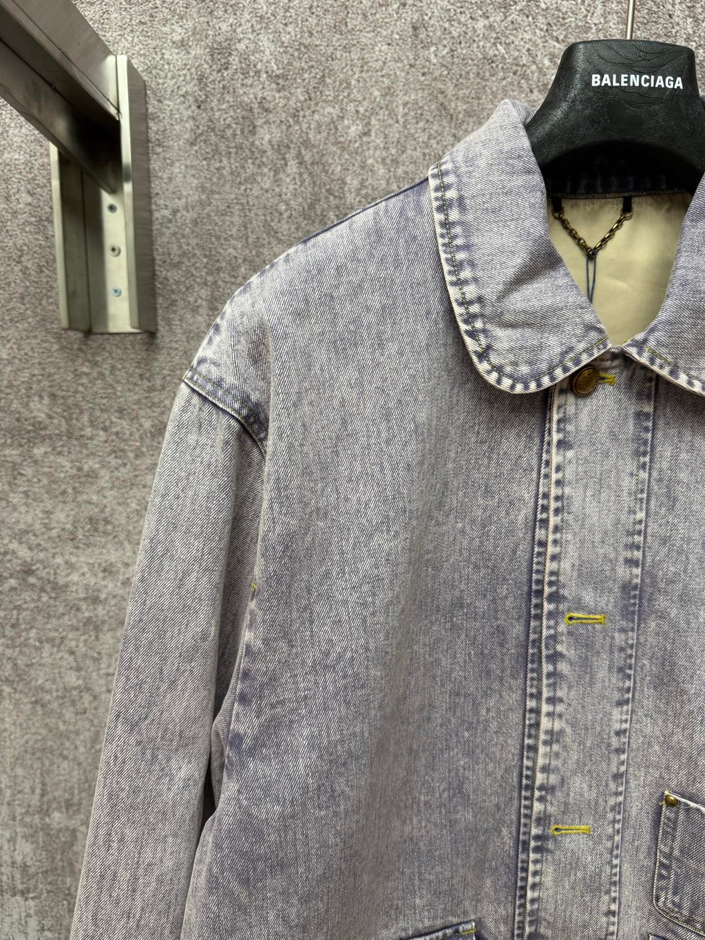 Light blue denim jacket front view with spread collar and buttoned chest pocket