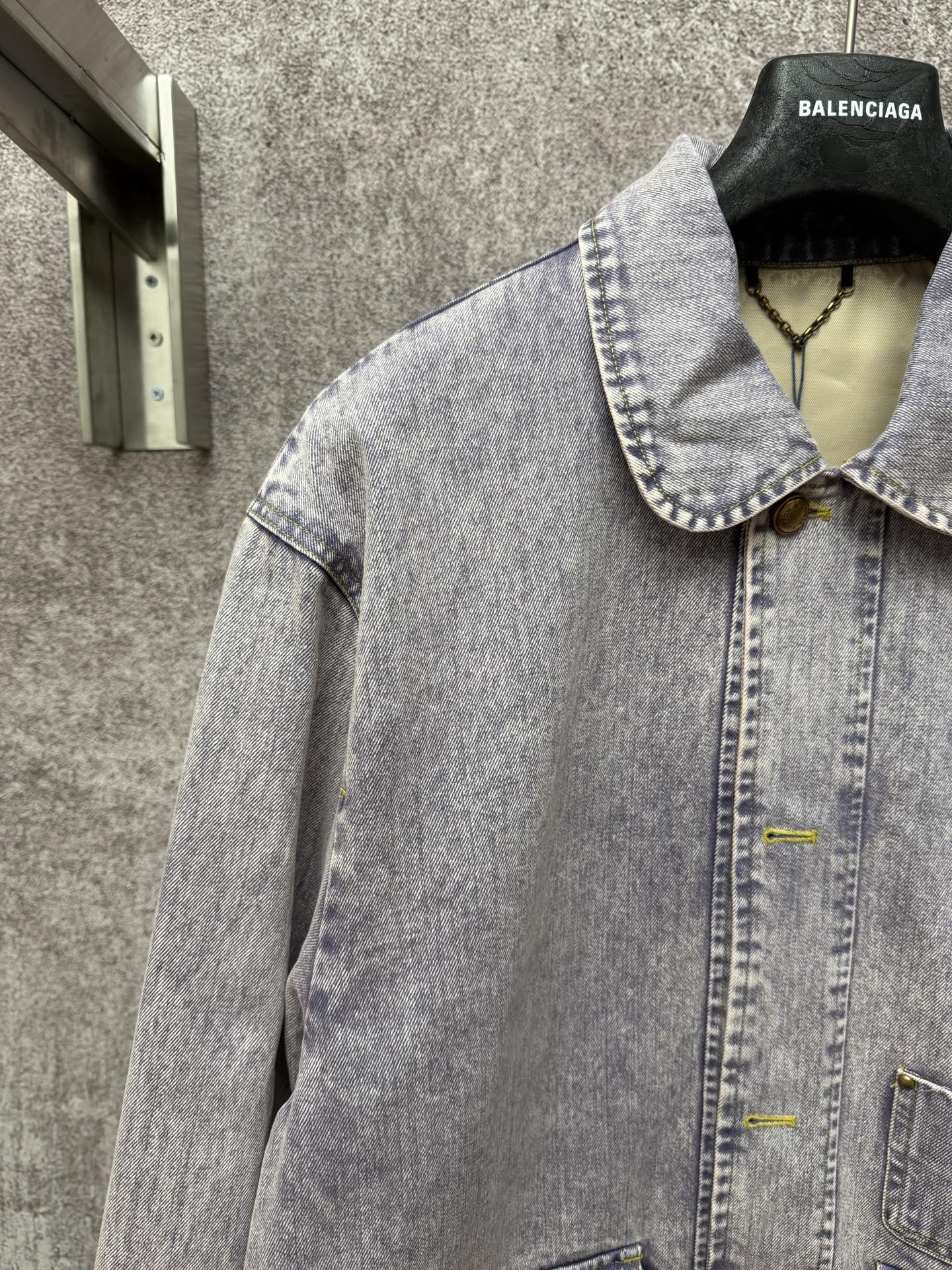 Light blue denim jacket front view with spread collar and buttoned chest pocket