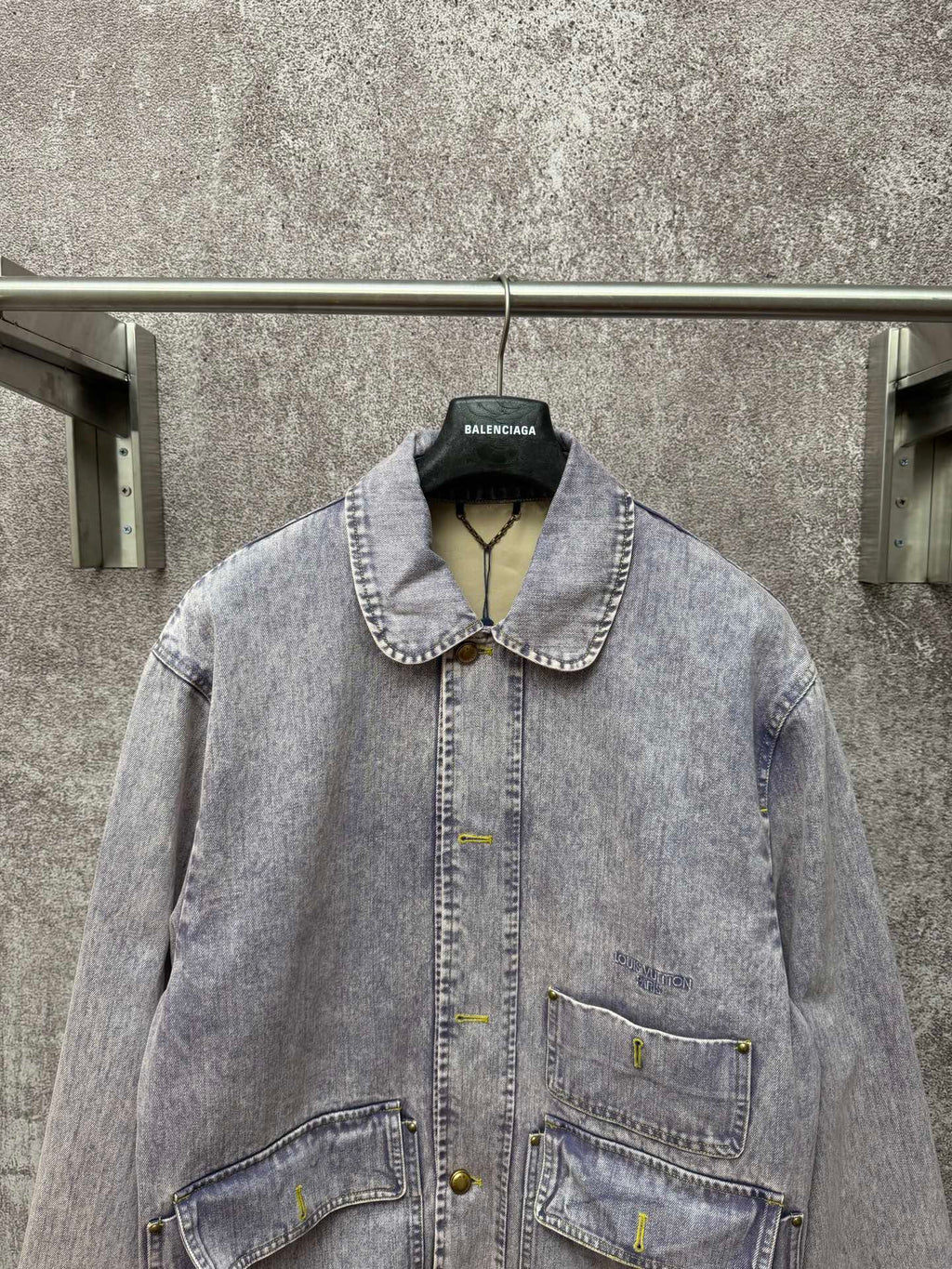 Light blue denim jacket front view with spread collar and two chest flap pockets