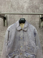 Light blue denim jacket front view with spread collar and two chest flap pockets