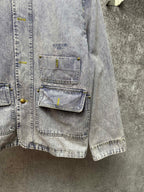 Light blue denim jacket side view with chest pockets and button details