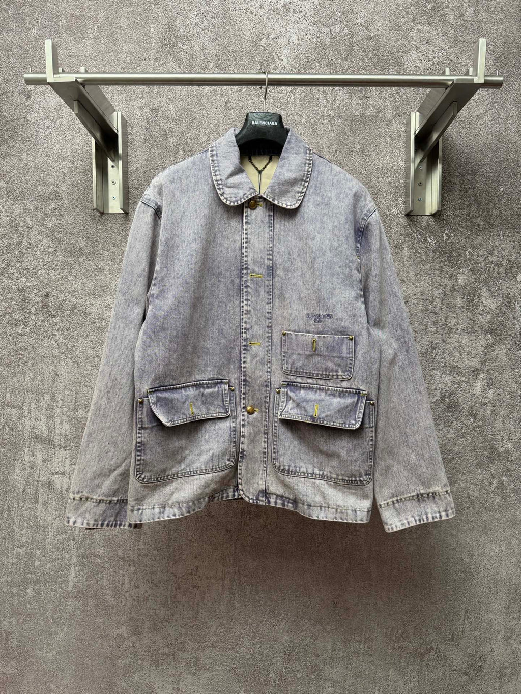 Light blue denim jacket with button front, point collar, and two chest flap pockets