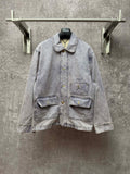 Light blue denim jacket with button front, point collar, and two chest flap pockets