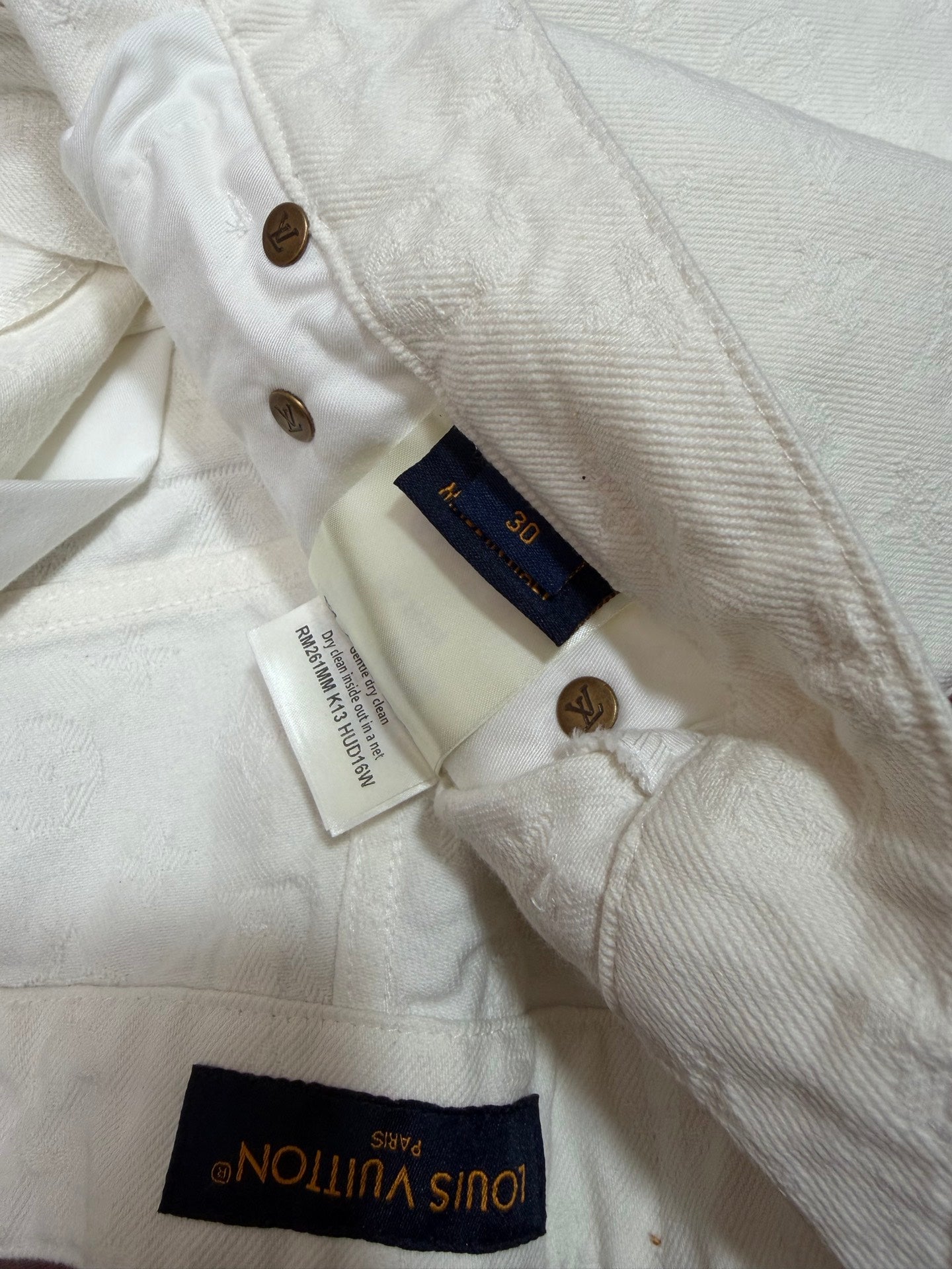 White shorts with Louis Vuitton label and size care tags