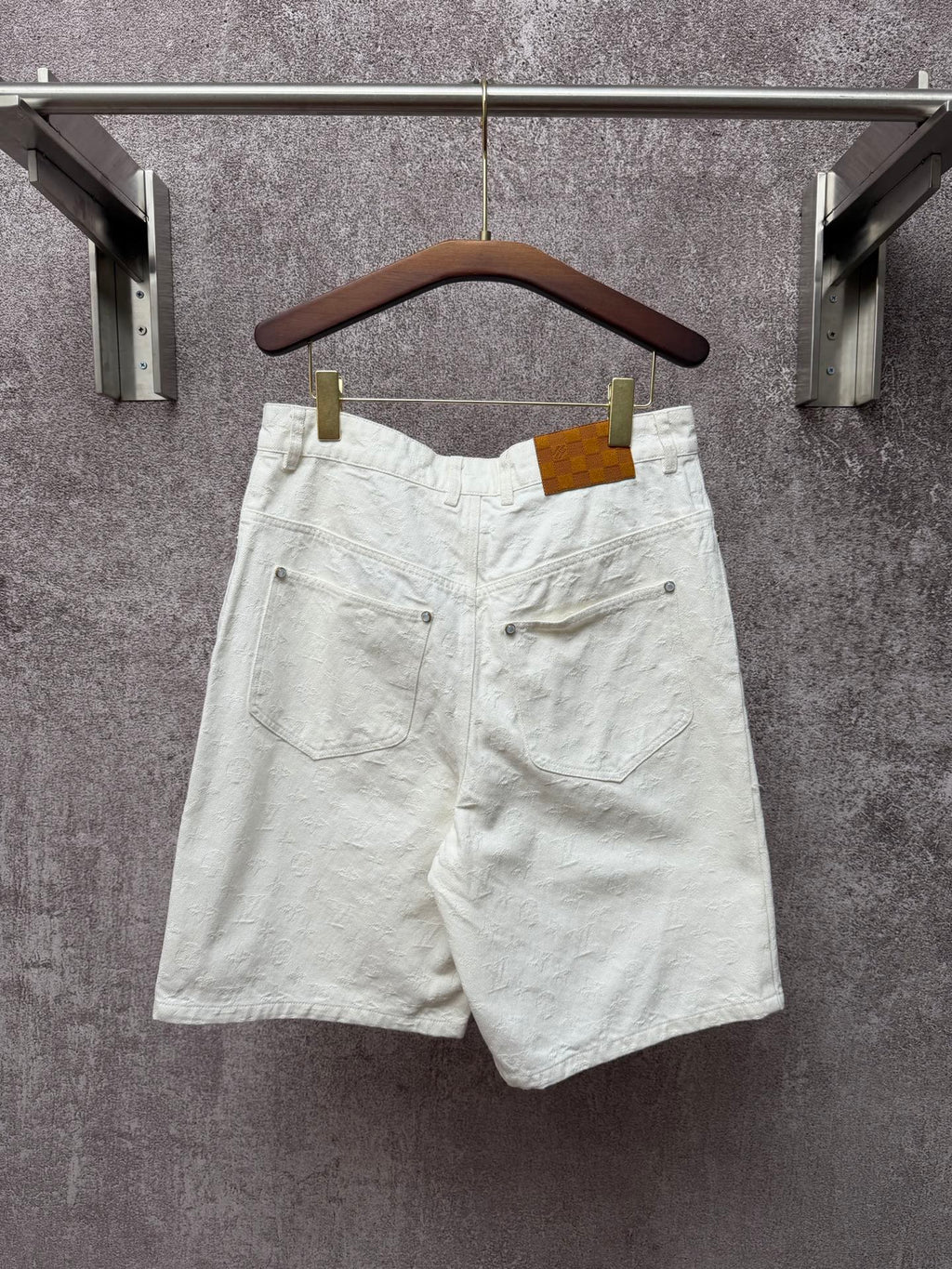 White shorts with rear pockets, button closure, and belt loops