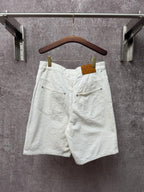 White shorts with rear pockets, button closure, and belt loops