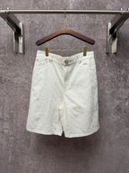White shorts with button closure, belt loops, and front slant pockets