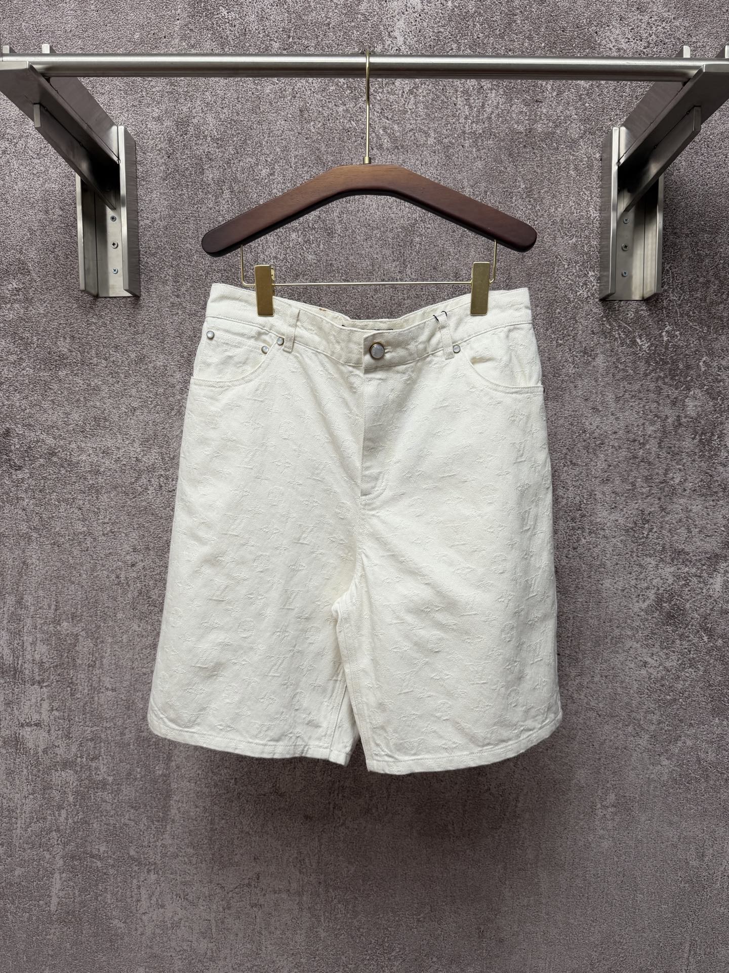 White shorts with button closure, belt loops, and front slant pockets
