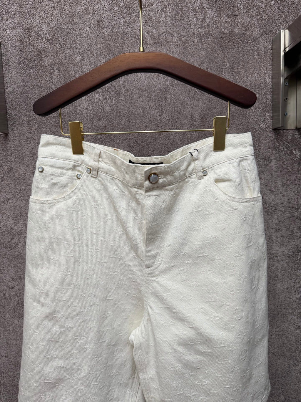 White shorts with elastic waistband, front button, and side pockets