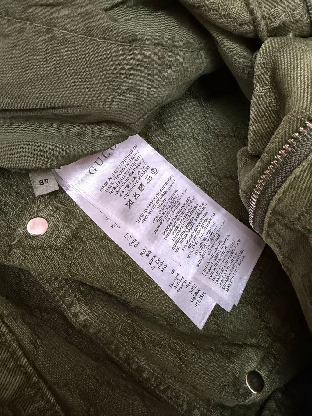 Green Gucci shorts fabric with care label near button
