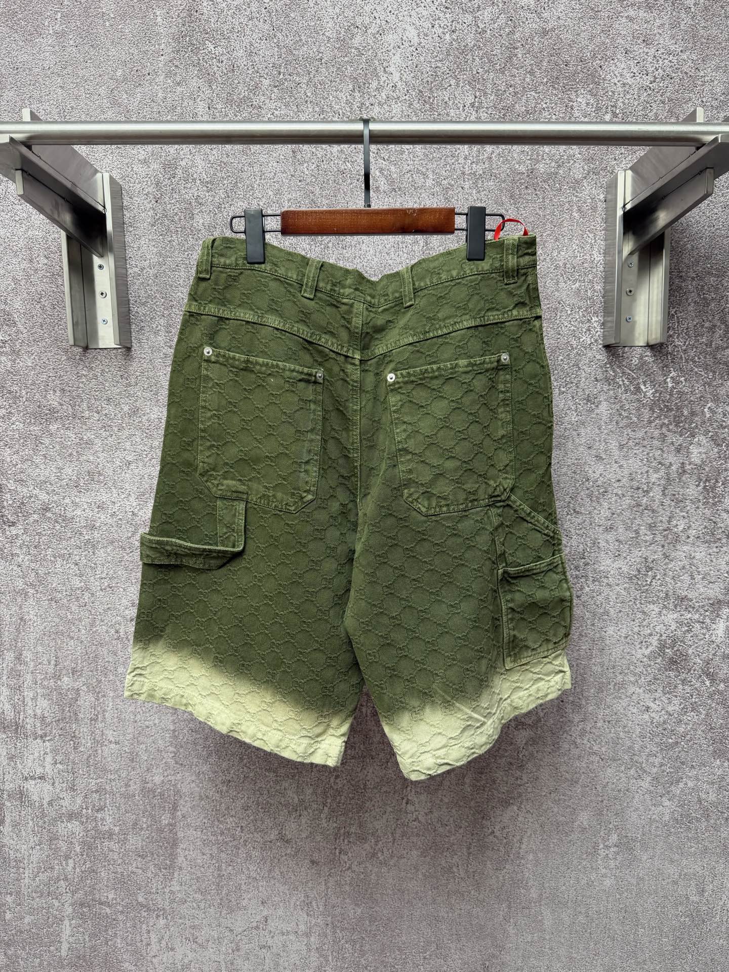 Green Gucci shorts with multiple pockets and belt loops, button closure
