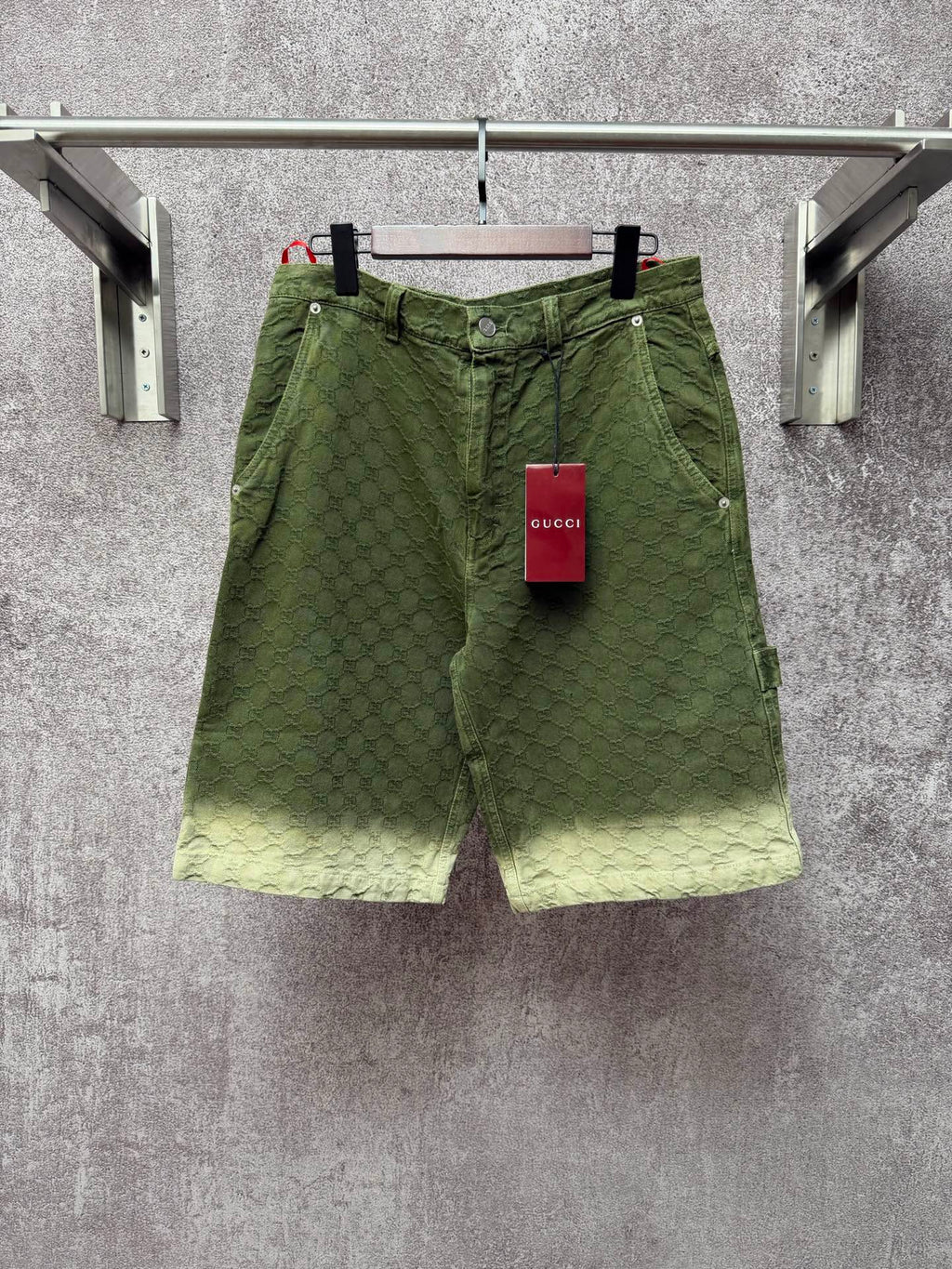 Green Gucci shorts with monogram pattern, button fly and belt loops
