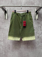 Green Gucci shorts with monogram pattern, button fly and belt loops