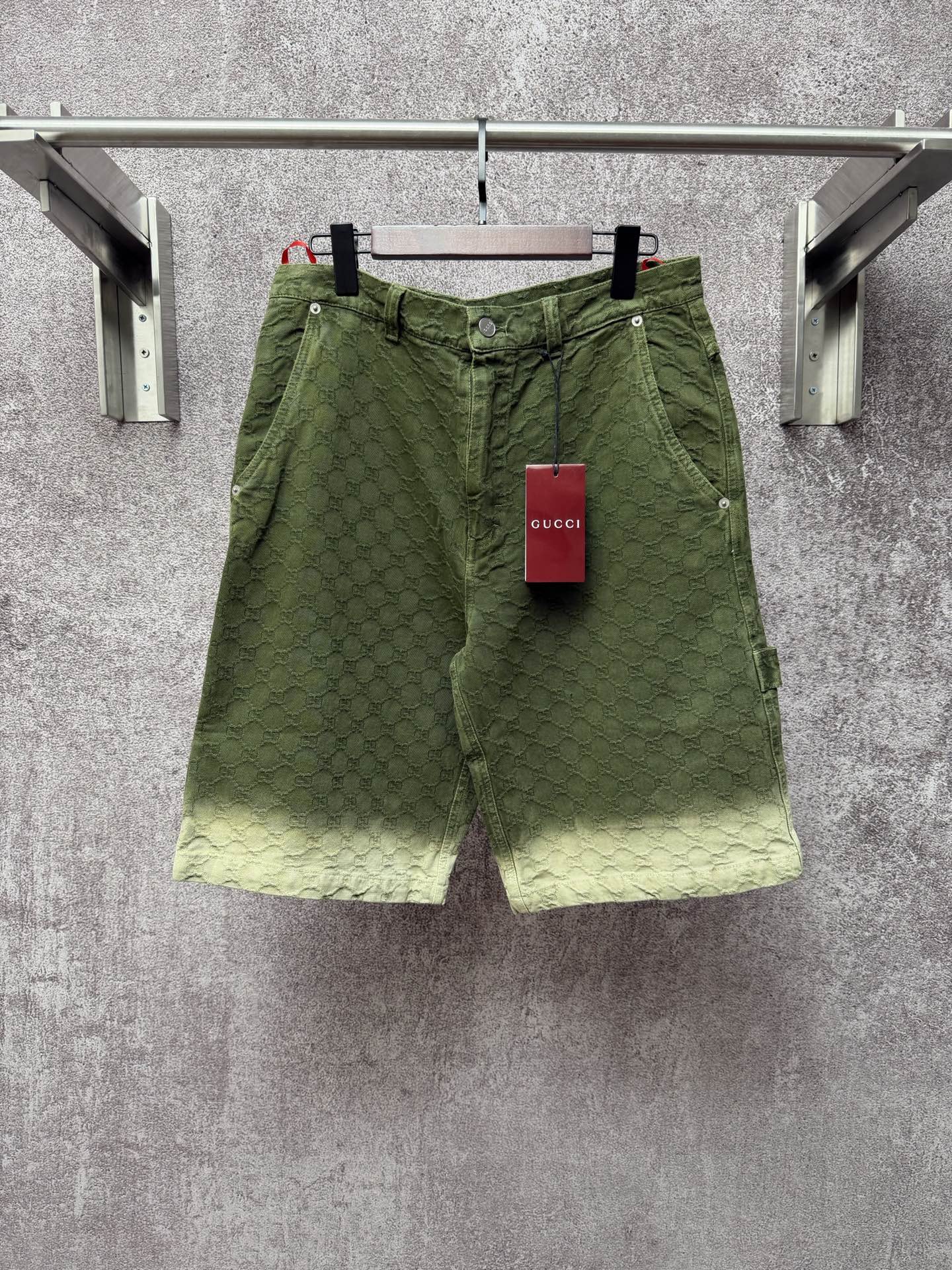 Green Gucci shorts with monogram pattern, button fly and belt loops