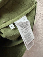 Gucci short-sleeve shirt care label tag on olive green textured fabric