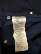 Gucci size and fabric label on navy shorts, close-up of inner tag and buttons