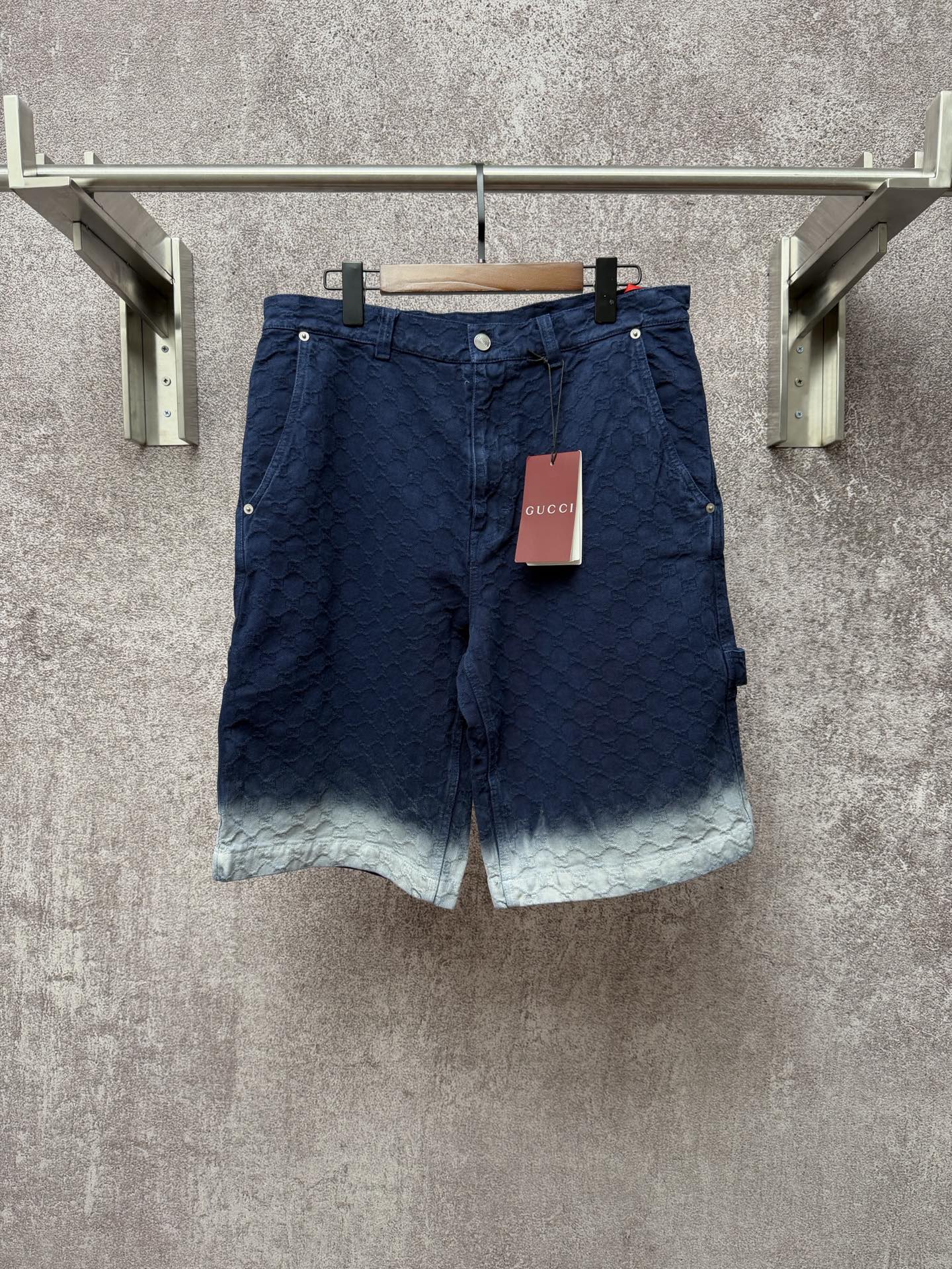 Gucci navy shorts with quilted texture and button front, light ombre hem