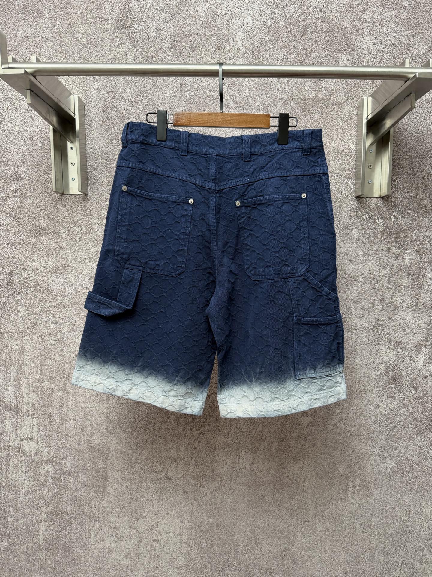 Gucci navy shorts with quilted texture and side cargo pocket, light ombre hem