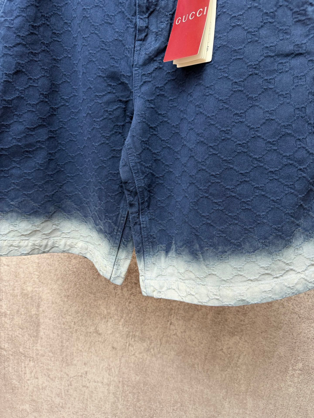 Gucci navy shorts with quilted texture and light ombre hem, button detail at front