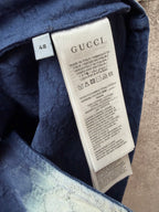 Gucci short-sleeve shirt care label near collar, dark blue fabric