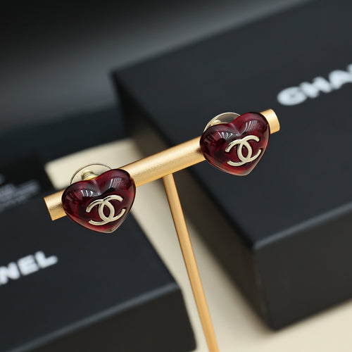 Red Chanel stud earrings with gold posts and interlocking CC logo