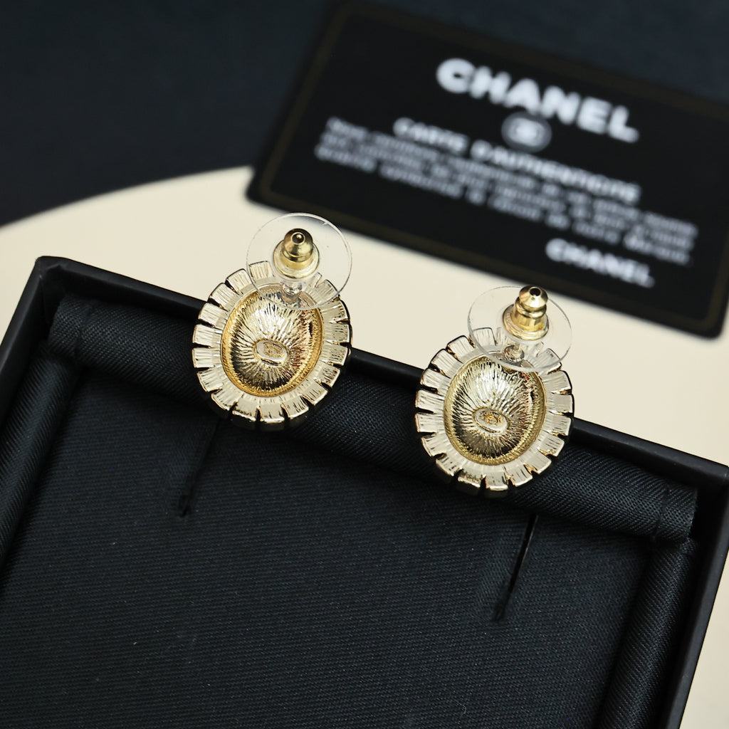 Gold-tone round logo stud earrings with red enamel and crystal border
