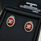 Red enamel logo stud earrings with silver-tone crystal halo detailing